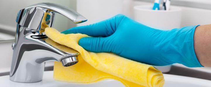 Wiping down the sink faucet