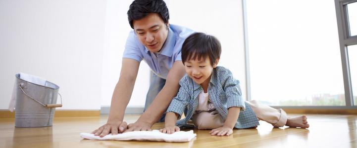 Father and son cleaning the floor together