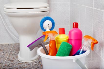 Bucket of cleaning products in a bathroom