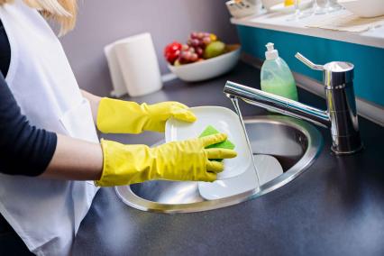 Woman washing dishes in the sink